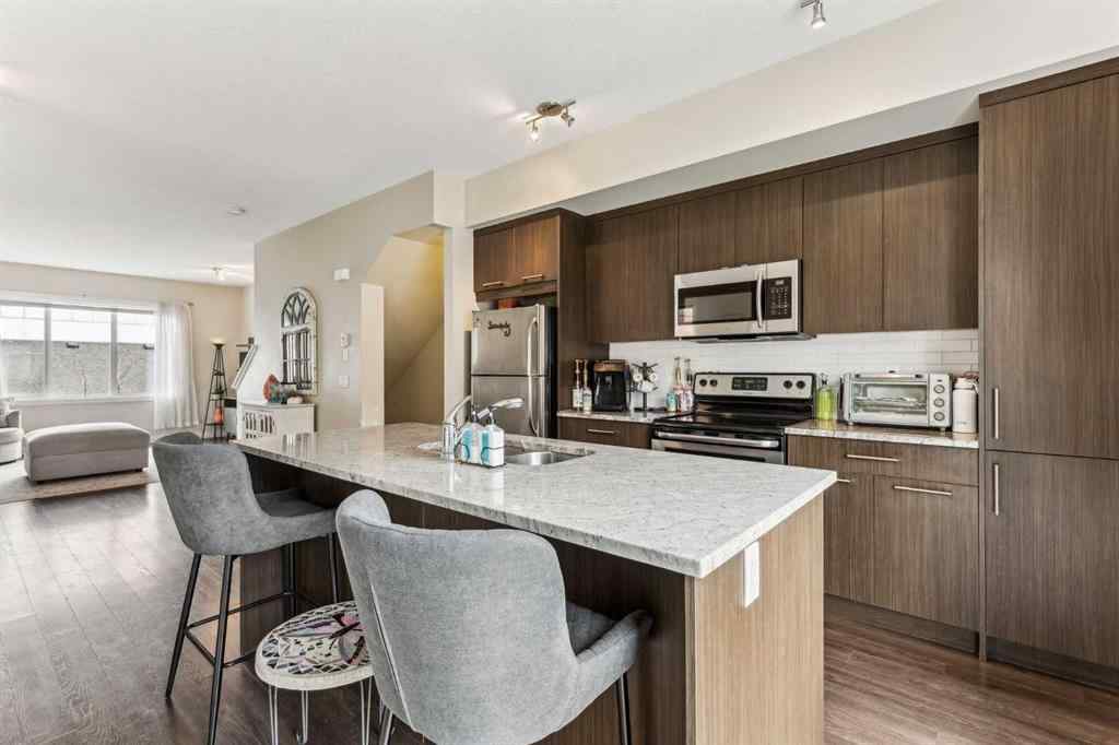 MLS® A2241328 - Unit #113 2802 Kings Heights Gate SE in Ravenswood Airdrie, Residential