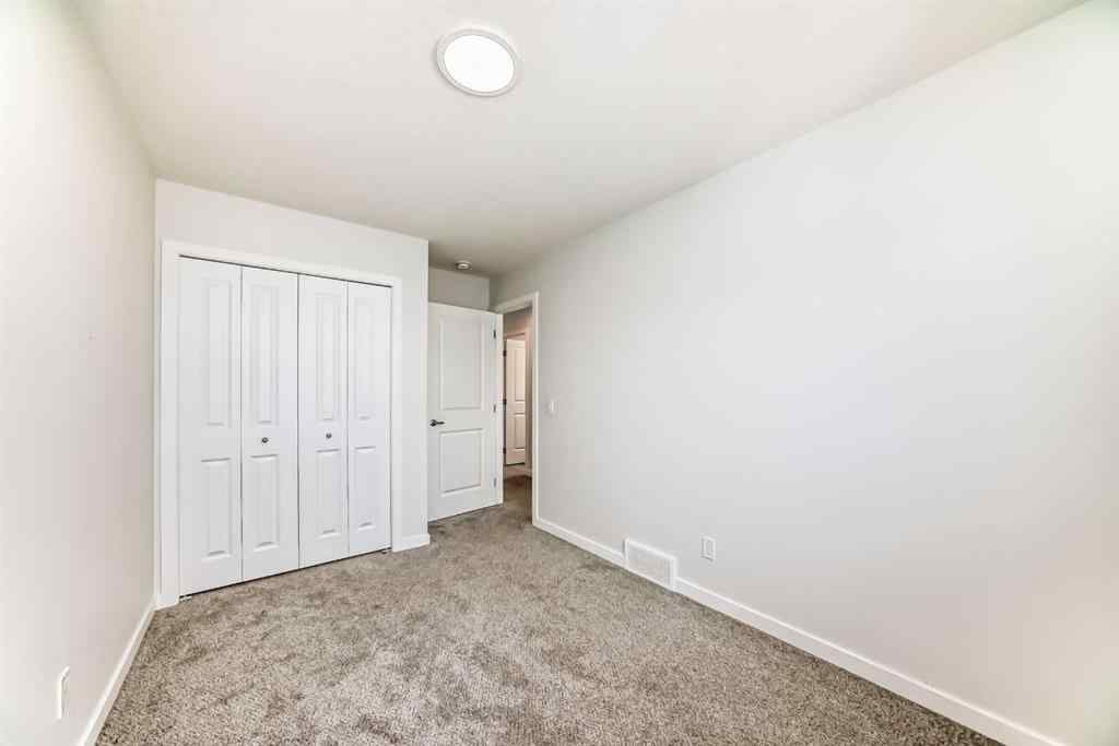 MLS® A2245235 - 21306 Sheriff King Street SW in Pine Creek Calgary, Residential