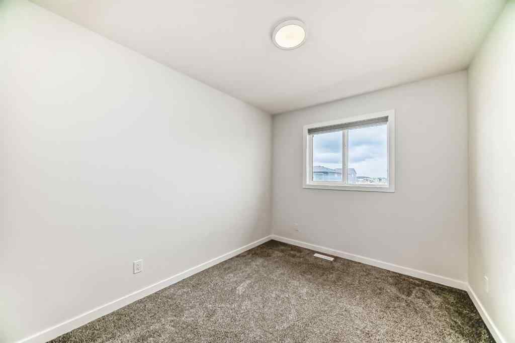 MLS® A2245235 - 21306 Sheriff King Street SW in Pine Creek Calgary, Residential