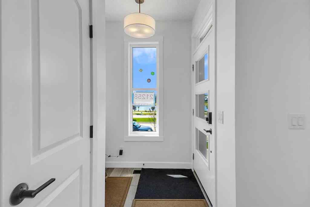 MLS® A2245350 - 21258 SHERIFF KING Street SW in Pine Creek Calgary, Residential