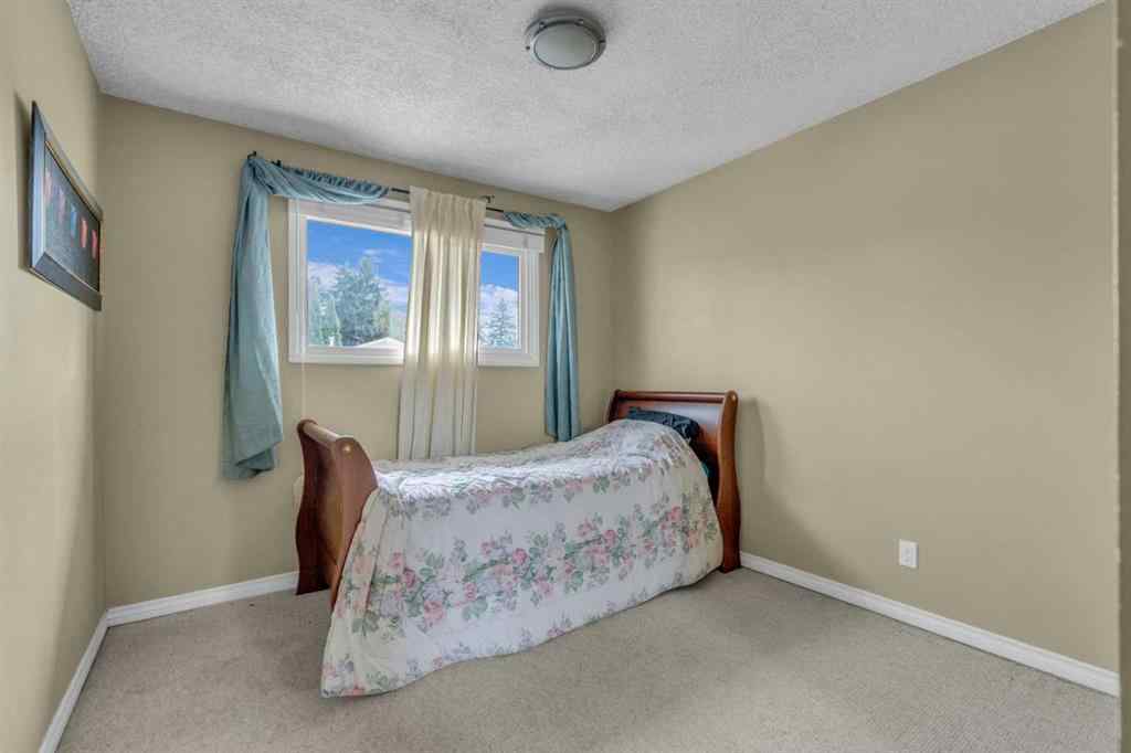 MLS® A2250254 - 403 Queen Alexandra Way SE in Queensland Calgary, Residential