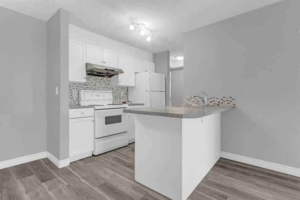 MLS® A2258662 - Unit #103 5555 Falsbridge Drive NE in Falconridge Calgary, Residential