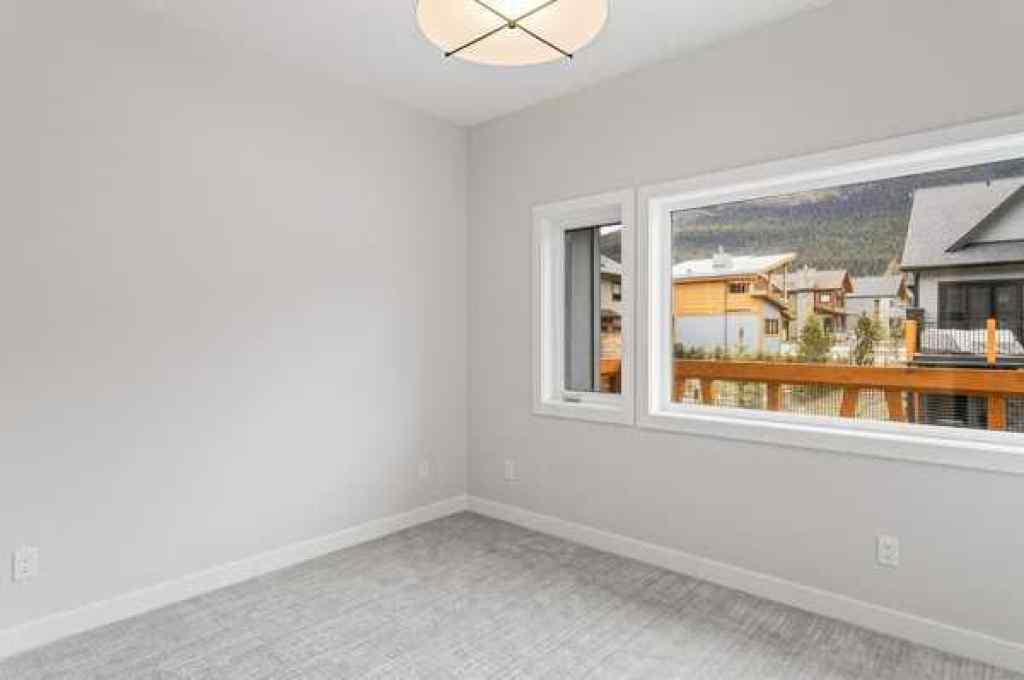 MLS® A2259828 - Unit #203J 209 Stewart Creek Rise  in Three Sisters Canmore, Residential