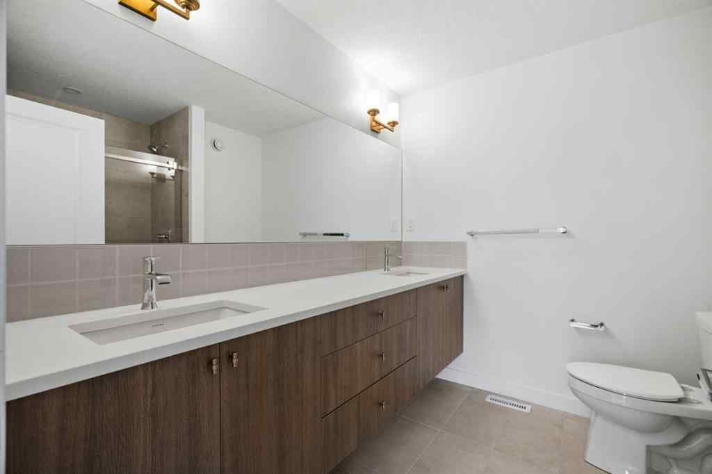 MLS® A2264976 - 8313 8 Avenue SW in West Springs Calgary, Residential