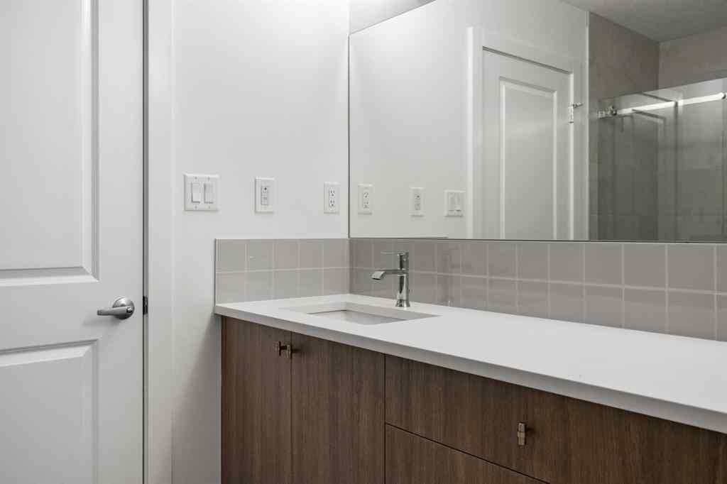 MLS® A2264976 - 8313 8 Avenue SW in West Springs Calgary, Residential