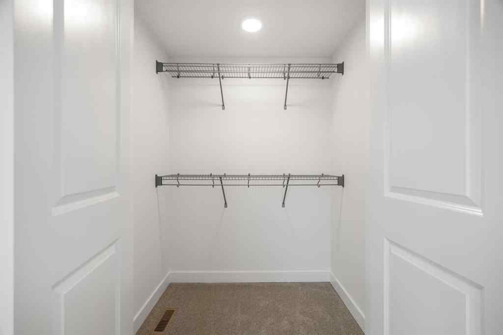 MLS® A2264976 - 8313 8 Avenue SW in West Springs Calgary, Residential