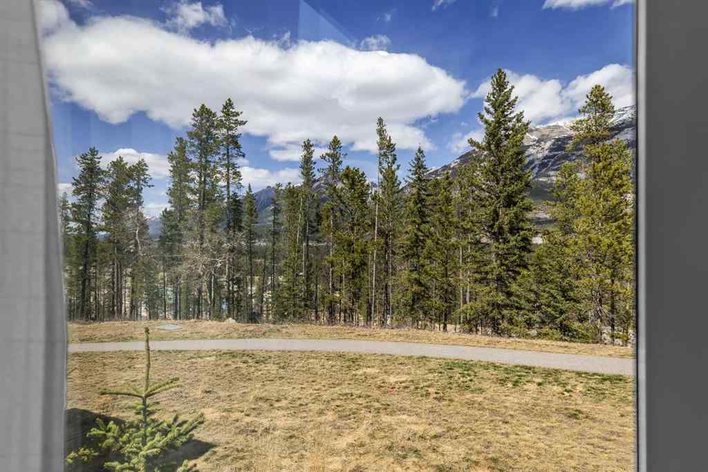 MLS® A2265553 - Unit #302 102 Stewart Creek Rise  in Three Sisters Canmore, Residential