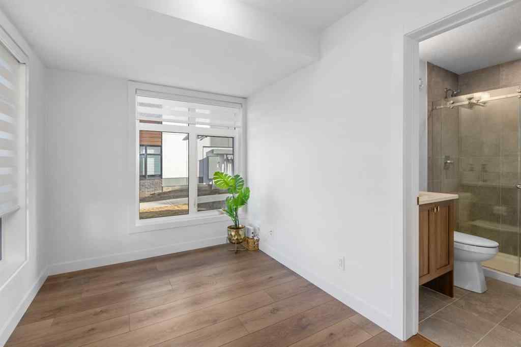 MLS® A2266099 - 8305 8 Avenue SW in West Springs Calgary, Residential