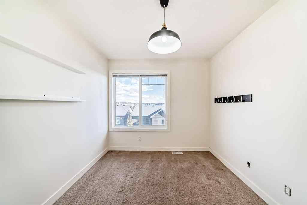 MLS® A2266106 - Unit #129 2802 Kings Heights Gate SE in Ravenswood Airdrie, Residential