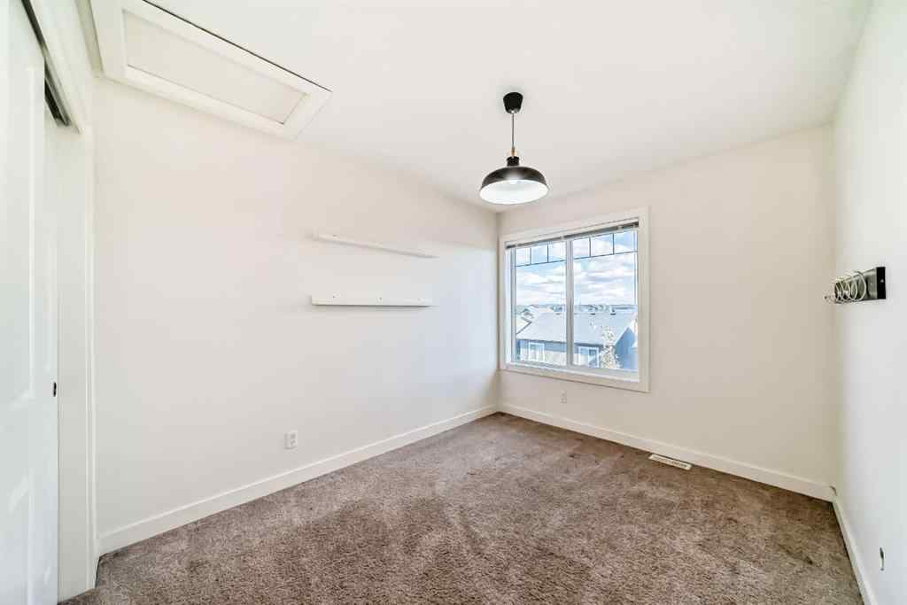 MLS® A2266106 - Unit #129 2802 Kings Heights Gate SE in Ravenswood Airdrie, Residential