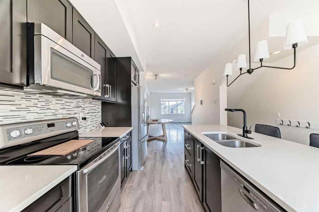 MLS® A2266106 - Unit #129 2802 Kings Heights Gate SE in Ravenswood Airdrie, Residential