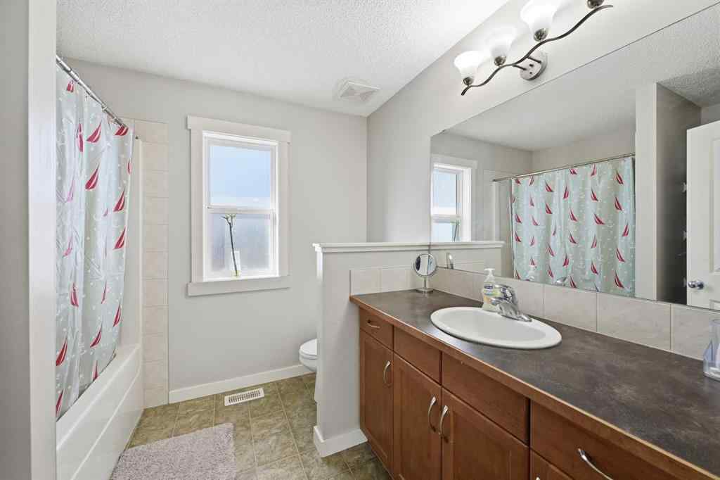 MLS® A2267001 - 217 coopers Grove SW in Coopers Crossing Airdrie, Residential
